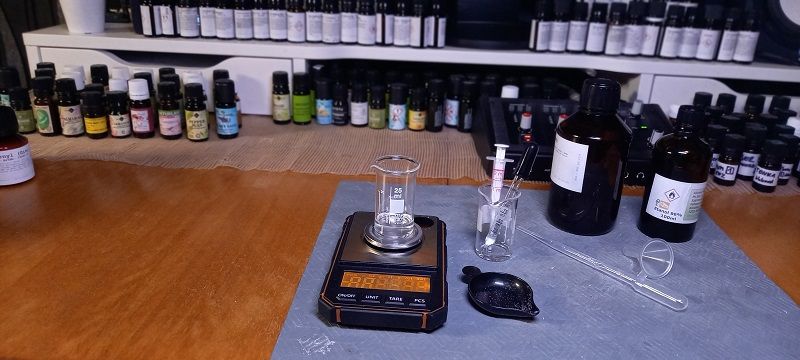 A scale, a beaker and raw materials on the workbench